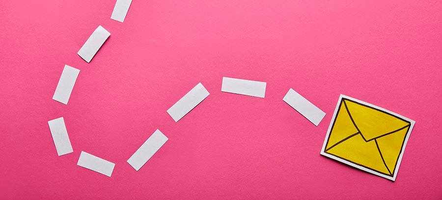 yellow envelope paper floating on pink background