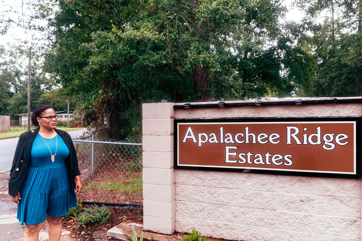 woman looking at sign that says apalachee ridge estates