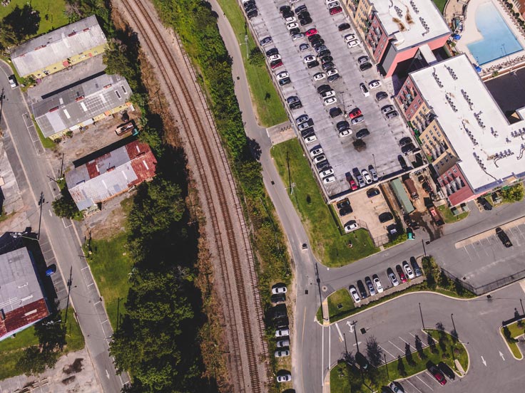 buildings on either side of railroad tracks, from the sky