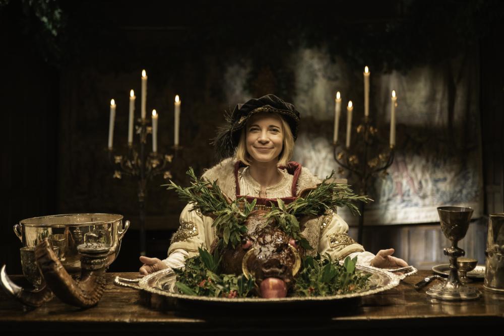 A woman holding a big roast