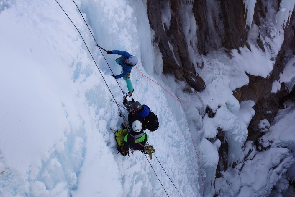 People ice climbing