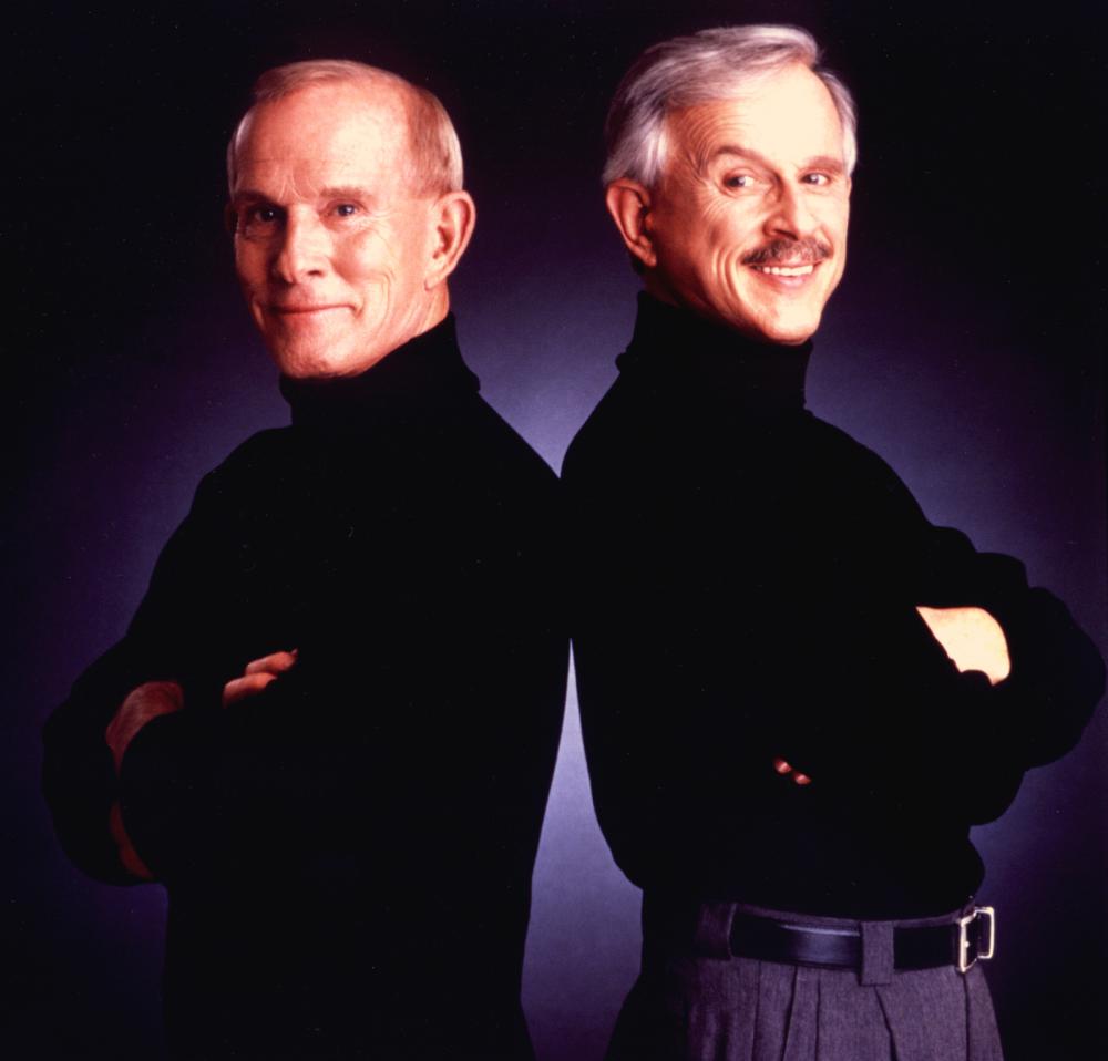 Two men standing back to back