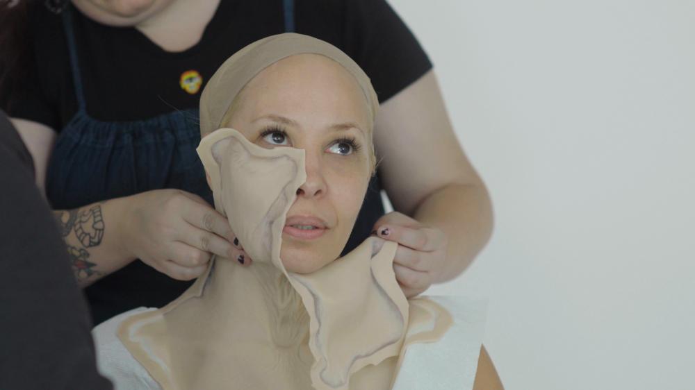 woman putting on aging suit