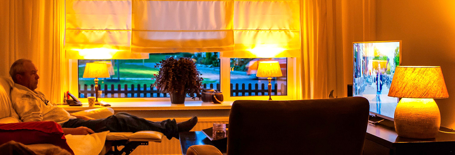 man on recliner watching tv